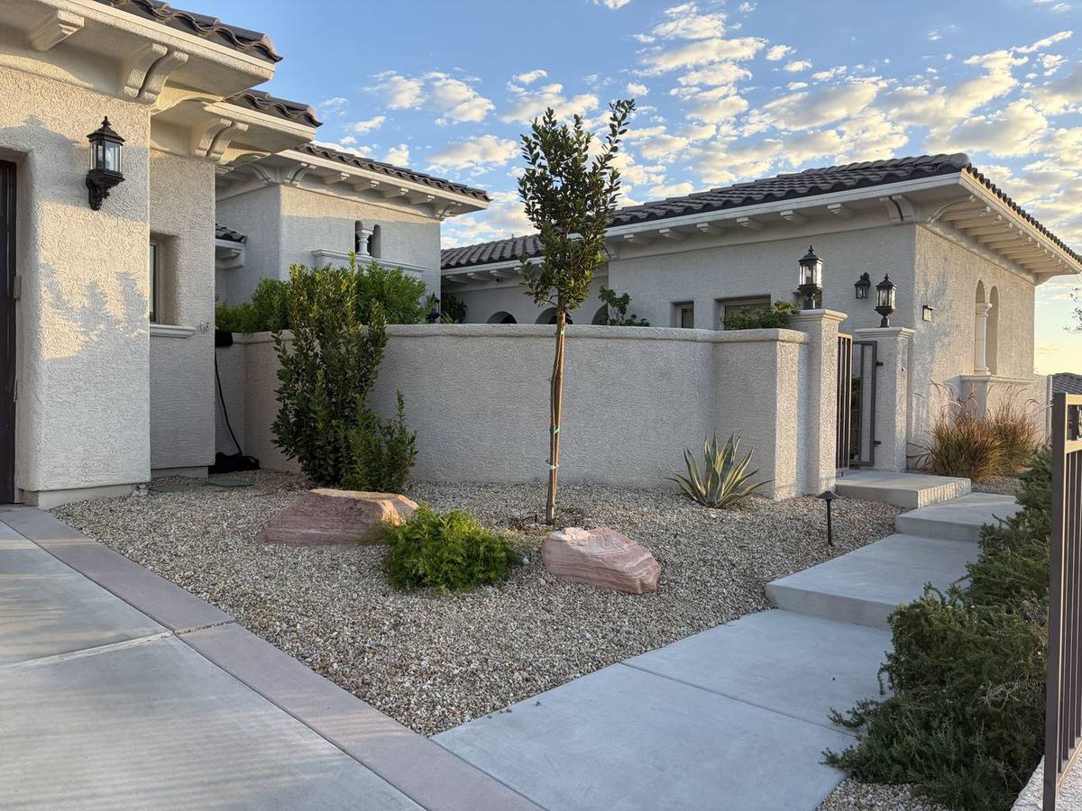 Courtyard gravel bed with agave, boulders, and fence edge